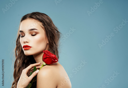 woman bright makeup rose in hand luxury blue background