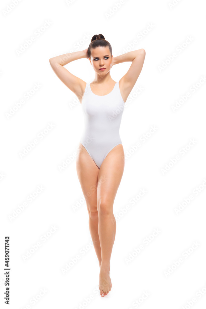 Young, fit and beautiful brunette woman in white swimsuit isolated on white background. Healthcare, diet, sport and fitness. Young, fit and beautiful brunette woman in white swimsuit isolated on white background. Healthcare, diet, sport and fitness.