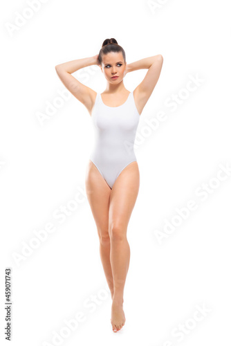 Young  fit and beautiful brunette woman in white swimsuit isolated on white background. Healthcare  diet  sport and fitness.