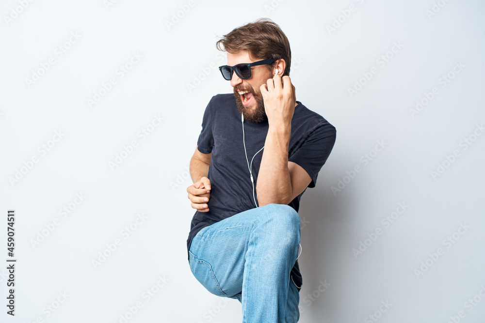 Cheerful man headphones sunglasses music dance fun light background Cheerful man headphones sunglasses music dance fun light background
