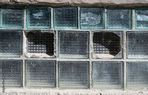 ragment of an old wall made of cracked  glass blocks photo