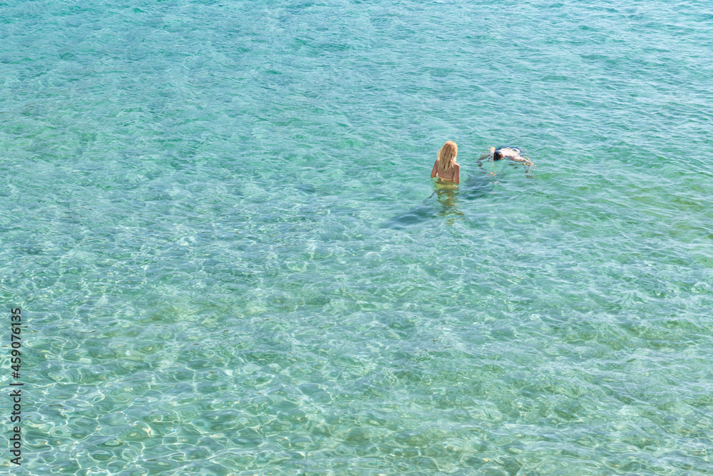 Young Couple in the cristal clear Seawater at the Mediterranean coast-7439