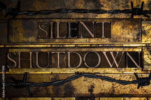 Silent Shutdown text on textured grunge copper and vintage gold background photo