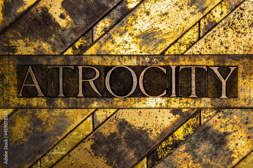 Atrocity text on textured grunge copper and vintage gold background