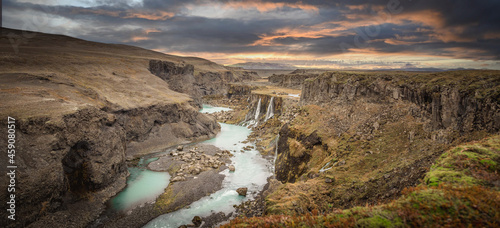 Beautiful sunset and landscape of Sigoldugljufur canyon with many small waterfalls and the blue river in Highlands of Iceland photo