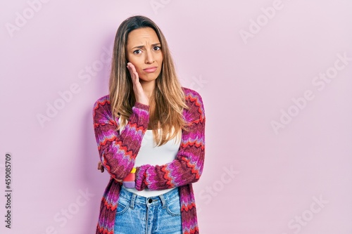 Beautiful hispanic woman wearing colored jacket thinking looking tired and bored with depression problems with crossed arms.