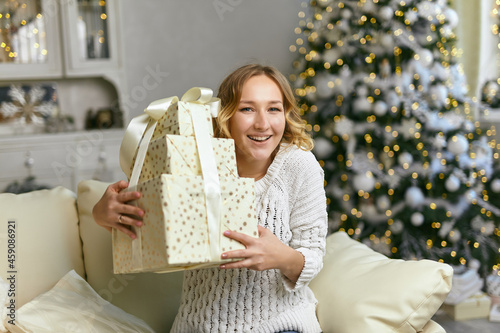 Happy Black Lady Holding And Embracing Gift Boxes photo