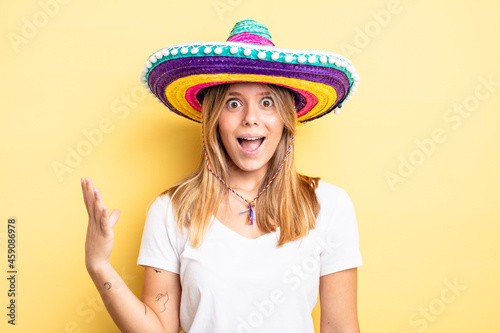 pretty blonde girl feeling happy, surprised realizing a solution or idea. mexican hat concept
