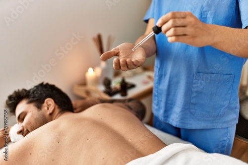 Man reciving back massage at beauty center. photo