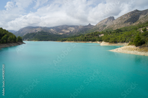turquoise blue water of the Guadalest lake in the mountains travel and relaxation background