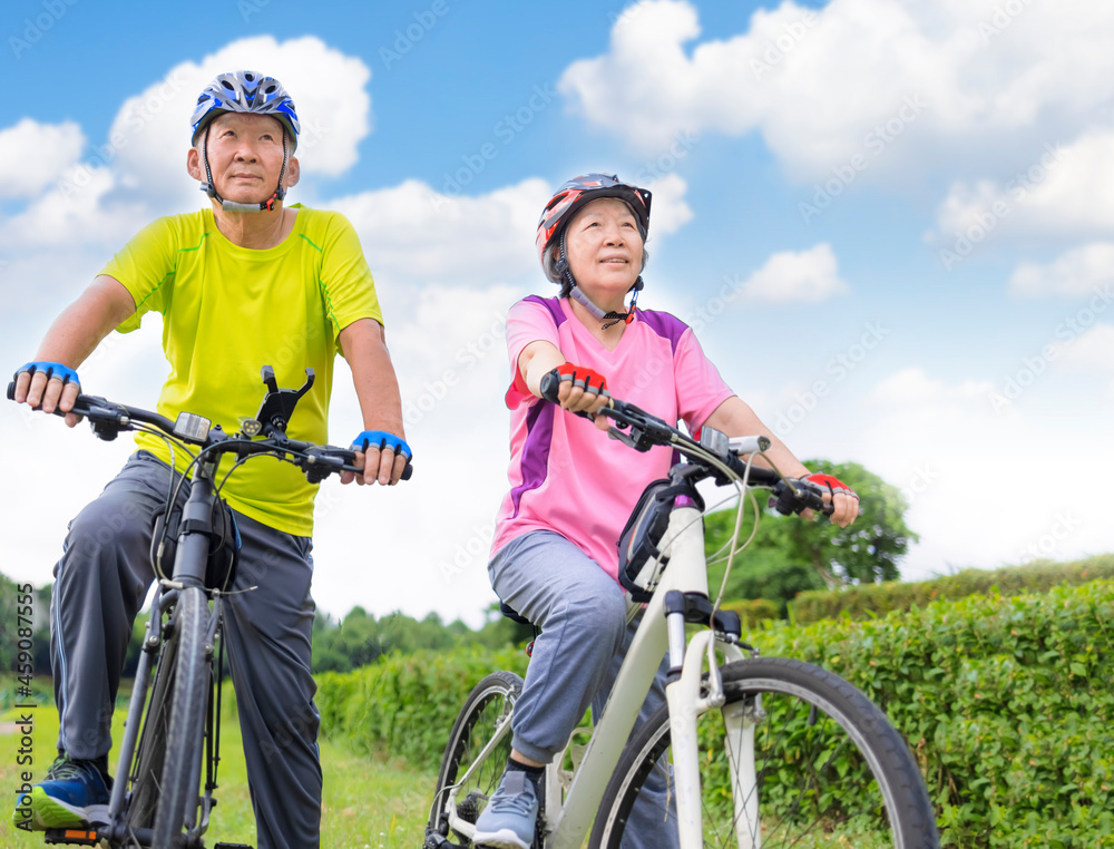 Happy  senior couple exercising with bicycles