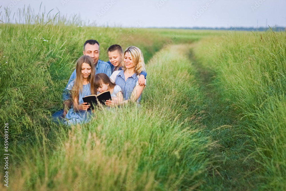 A Happy family read a book on nature in the park A Happy family read a book on nature in the park