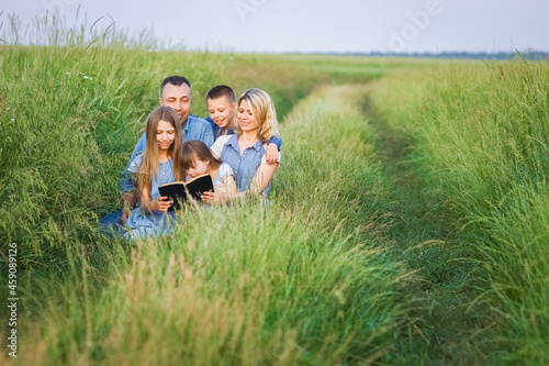 A Happy family read a book on nature in the park