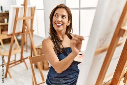 Young hispanic artist woman smiling happy drawing at art studio. Free Download Young hispanic artist woman smiling happy drawing at art studio. - GFXLoad
