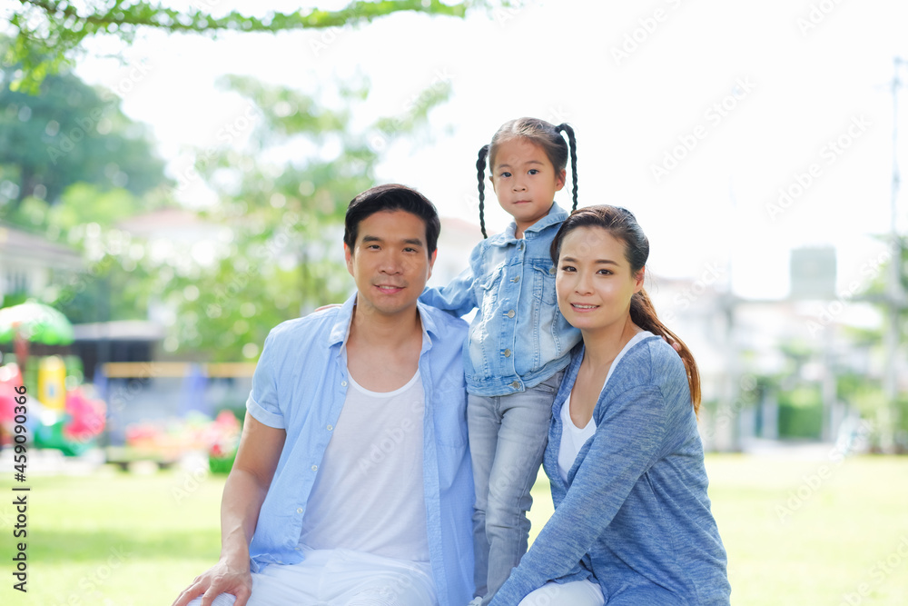 Happy asian family together with daughter in park Happy asian family together with daughter in park