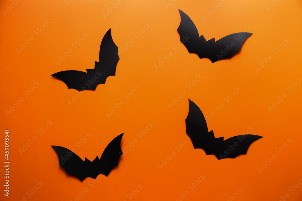 Naklejka premium Bats on an orange background. Happy Halloween