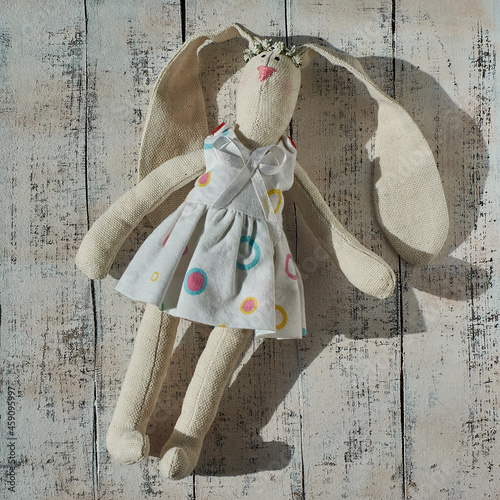Little toy tilda banny in a dress. Toy rabbit. photo
