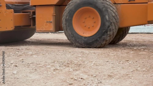 Video ground level of steamroller compacting the soil in the construction site photo