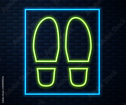Glowing neon line Footsteps icon isolated on brick wall background. Detective is investigating. To follow in the footsteps. Vector