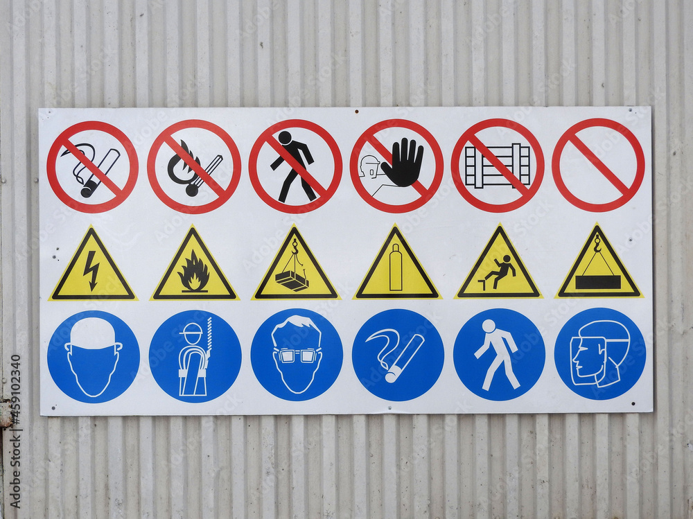 Informative panel with prohibitive and permissive signs attached to the metal fence of the construction site. Informative panel with prohibitive and permissive signs attached to the metal fence of the construction site.