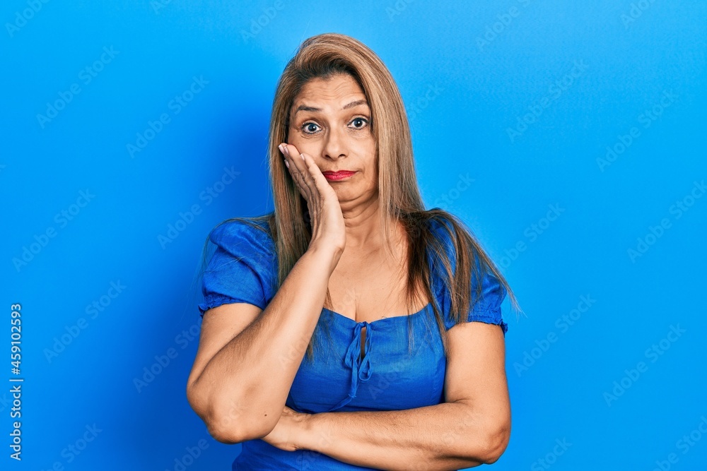 Middle age hispanic woman wearing casual clothes thinking looking tired and bored with depression problems with crossed arms. Middle age hispanic woman wearing casual clothes thinking looking tired and bored with depression problems with crossed arms.