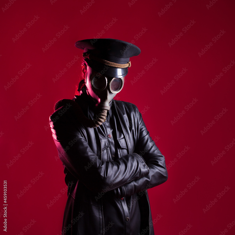 An evil Character in black leather clothes and a military cap An evil Character in black leather clothes and a military cap