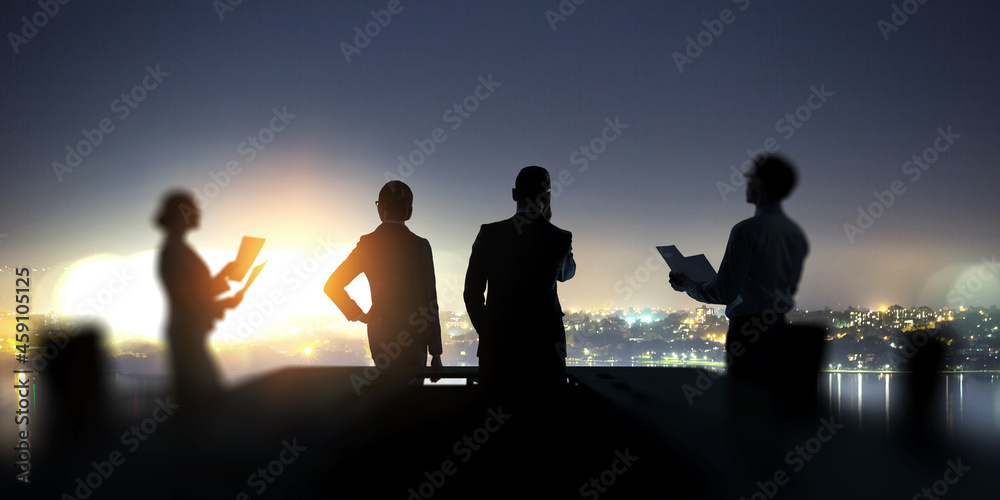 Group of business people outlines with lit background . Mixed media