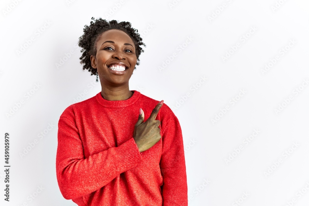 Young african american woman wearing casual clothes over isolated background cheerful with a smile of face pointing with hand and finger up to the side with happy and natural expression on face Young african american woman wearing casual clothes over isolated background cheerful with a smile of face pointing with hand and finger up to the side with happy and natural expression on face
