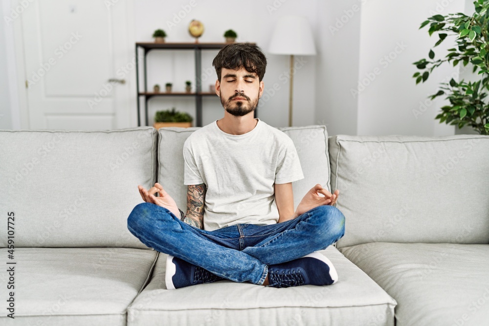 Young hispanic man concentrate meditating at home Young hispanic man concentrate meditating at home