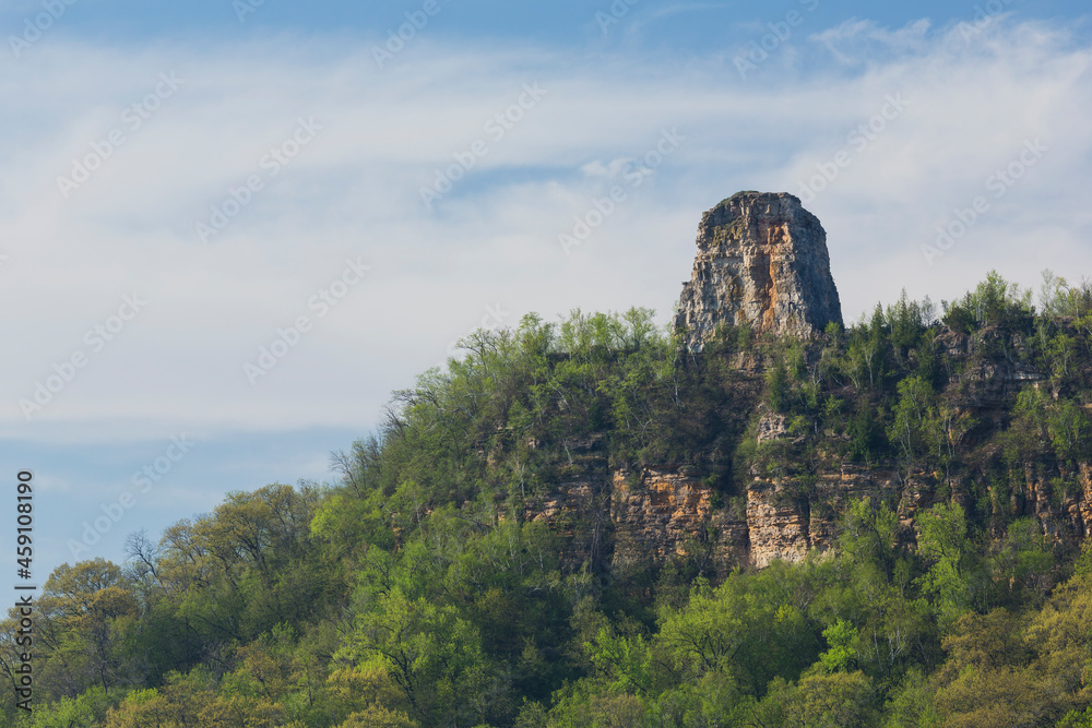 A Rock Formation On Top Of A Hill In Spring