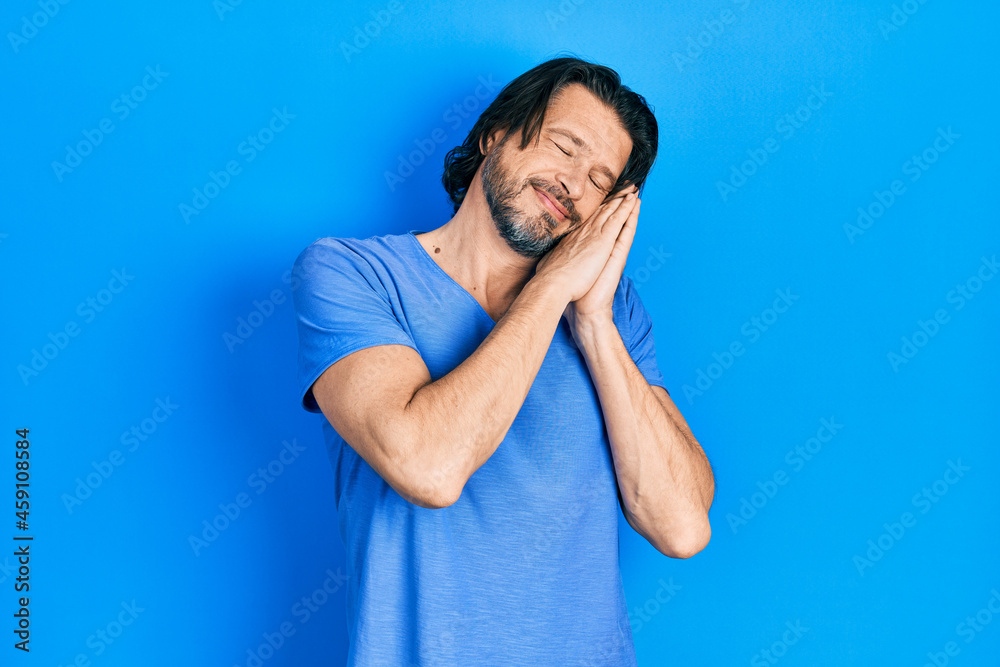 Middle age caucasian man wearing casual clothes sleeping tired dreaming and posing with hands together while smiling with closed eyes.
