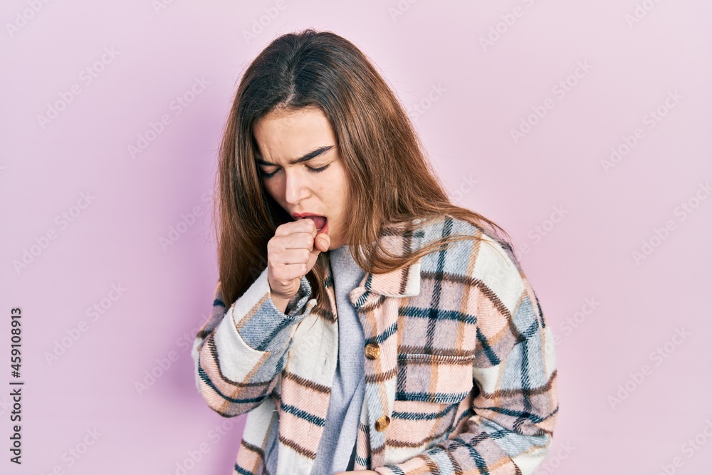 Young caucasian girl wearing casual clothes feeling unwell and coughing as symptom for cold or bronchitis. health care concept. Young caucasian girl wearing casual clothes feeling unwell and coughing as symptom for cold or bronchitis. health care concept.