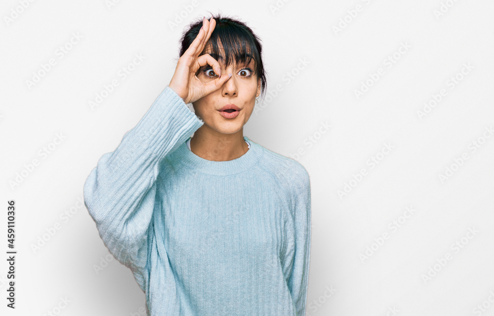 Young hispanic woman wearing casual clothes doing ok gesture shocked with surprised face, eye looking through fingers. unbelieving expression. Young hispanic woman wearing casual clothes doing ok gesture shocked with surprised face, eye looking through fingers. unbelieving expression.