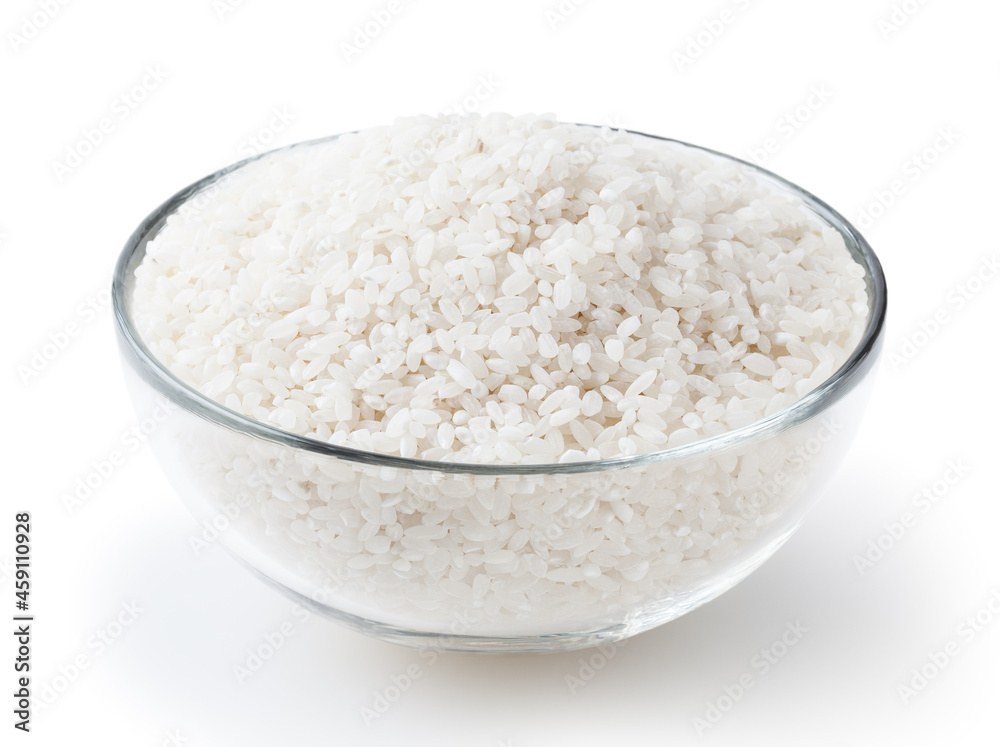 Uncooked round rice in glass bowl isolated on white background with clipping path