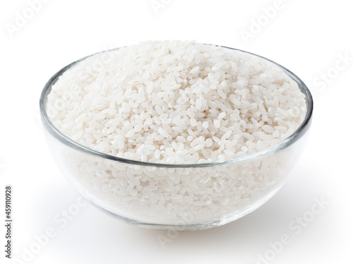 Uncooked round rice in glass bowl isolated on white background with clipping path