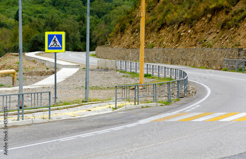 asphalt mountain road with pedestrian crossing
