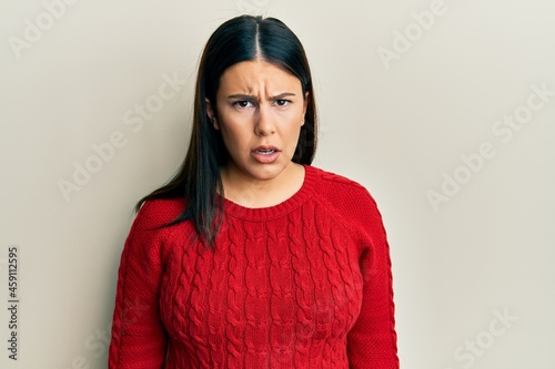 Beautiful brunette woman wearing wool winter sweater skeptic and nervous, frowning upset because of problem. negative person. © Krakenimages.com