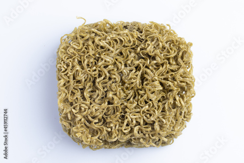 Instant noodles mixed with vegetables moroheiya moodle dry green lines on white background