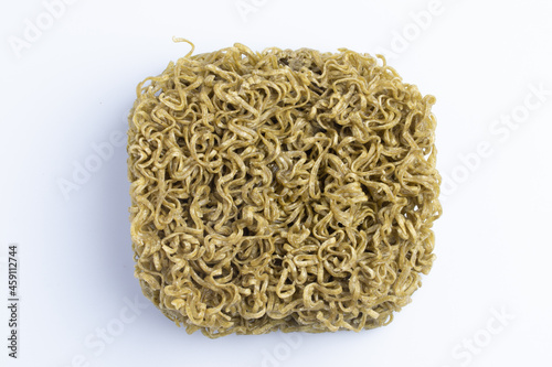 Instant noodles mixed with vegetables moroheiya moodle dry green lines on white background photo