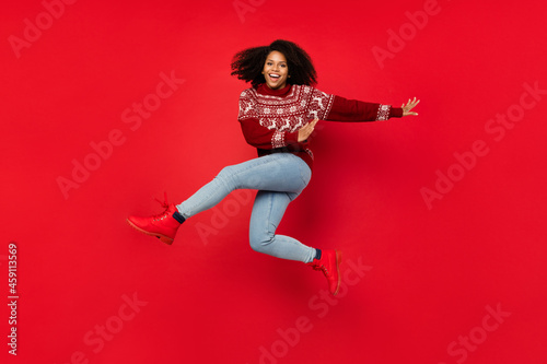 Full length body size view of attractive cheerful girl jumping having fun dancing isolated over shine red color background
