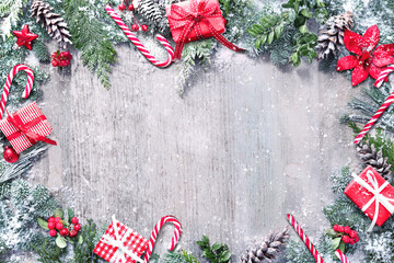 Christmas and New Year background with fir branches and snowfall on wooden white board