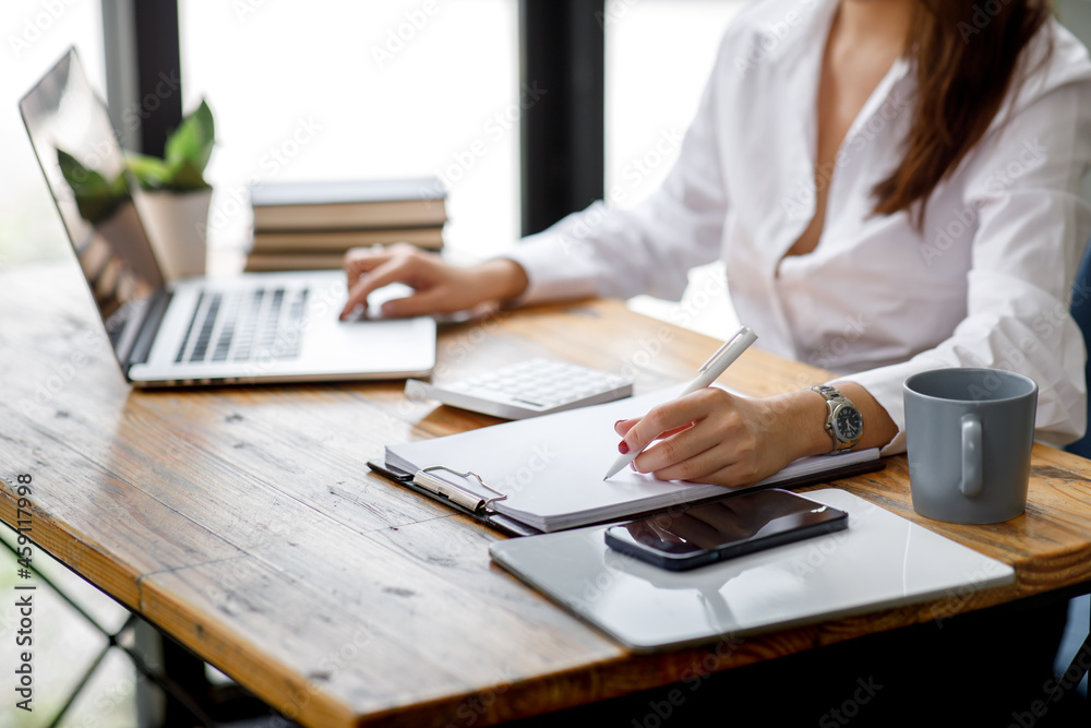 Fototapeta premium Close up of hand, Financial Businesswomen analyze the graph of the company's performance to create profits and growth, Market research reports and income statistics, Financial and Accounting concept.