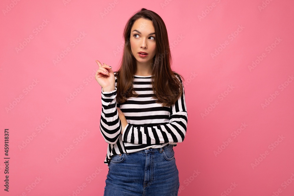 Photo shot of cute attractive pretty thoughful dreaming young brunette woman wearing casual striped longsleeve isolated over colorful background with copy space and having questions Photo shot of cute attractive pretty thoughful dreaming young brunette woman wearing casual striped longsleeve isolated over colorful background with copy space and having questions