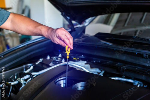 Check the oil level in car engine. Mechanic checking car engine or vehicle. Check and maintenance car with yourself. Service and maintenance vehicle.