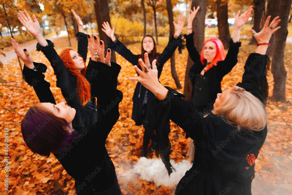 Coven of witches, a group of friends as witches on Halloween perform a