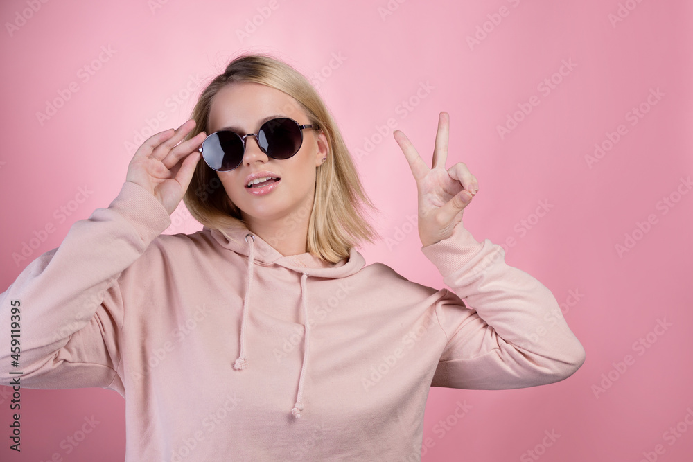 beautiful young woman with blonde hair wearing dark sunglasses. beautiful young woman with blonde hair wearing dark sunglasses.