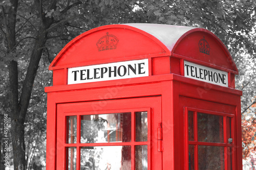 Black and white photo with red telephone booth in classic english style on black and white background in style of black and white retro photo as sample of black and white photo with red accent