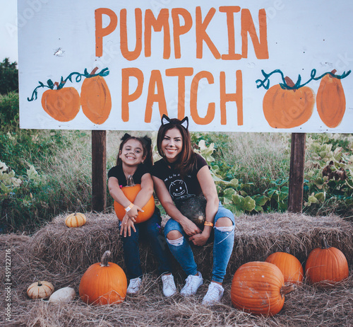 picking pumpkins in a pumpkin patch at farmer mikes u pick in Bonita springs Florida Looking for a local, pumpkin patch, corn maze, hayride, gourds and other Halloween activities in Florida photo