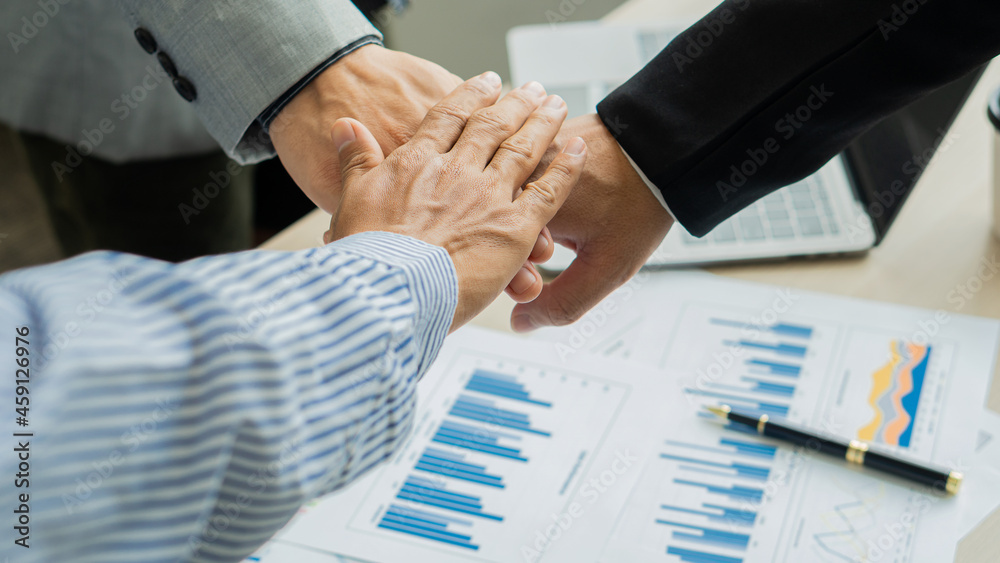 Obraz premium business people join hands to work as a team of business merger and successful negotiations 3 business people join hands with partners to celebrate partnership and business deal idea in office and on 