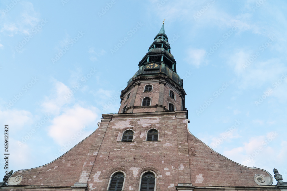 Fototapeta premium Riga St. Peter’s Church facade with the tower (Latvia) - one of the oldest and most valuable monuments of medieval architecture in the Baltic States included among the UNESCO World Heritage sites.